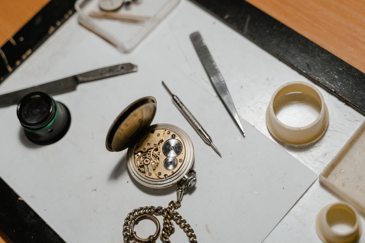 An opened mechanical watch movement with tools at Saltzman's Watches