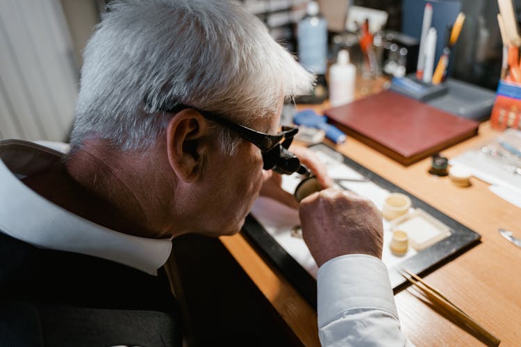 An Elderly Man Checking On A Pocket Watch