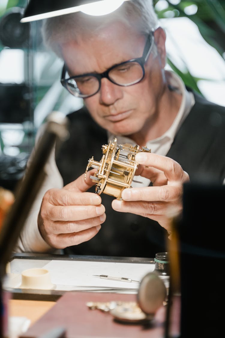 A Man Repairing A Clock