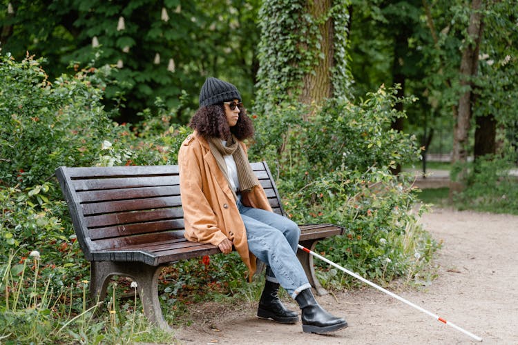 A Blind Woman Sitting On The Bench