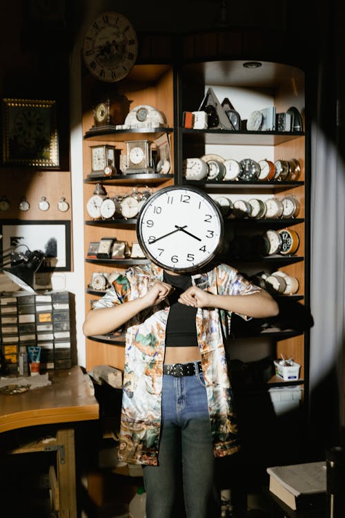 Free Woman Standing with Face Covered with Clock Stock Photo