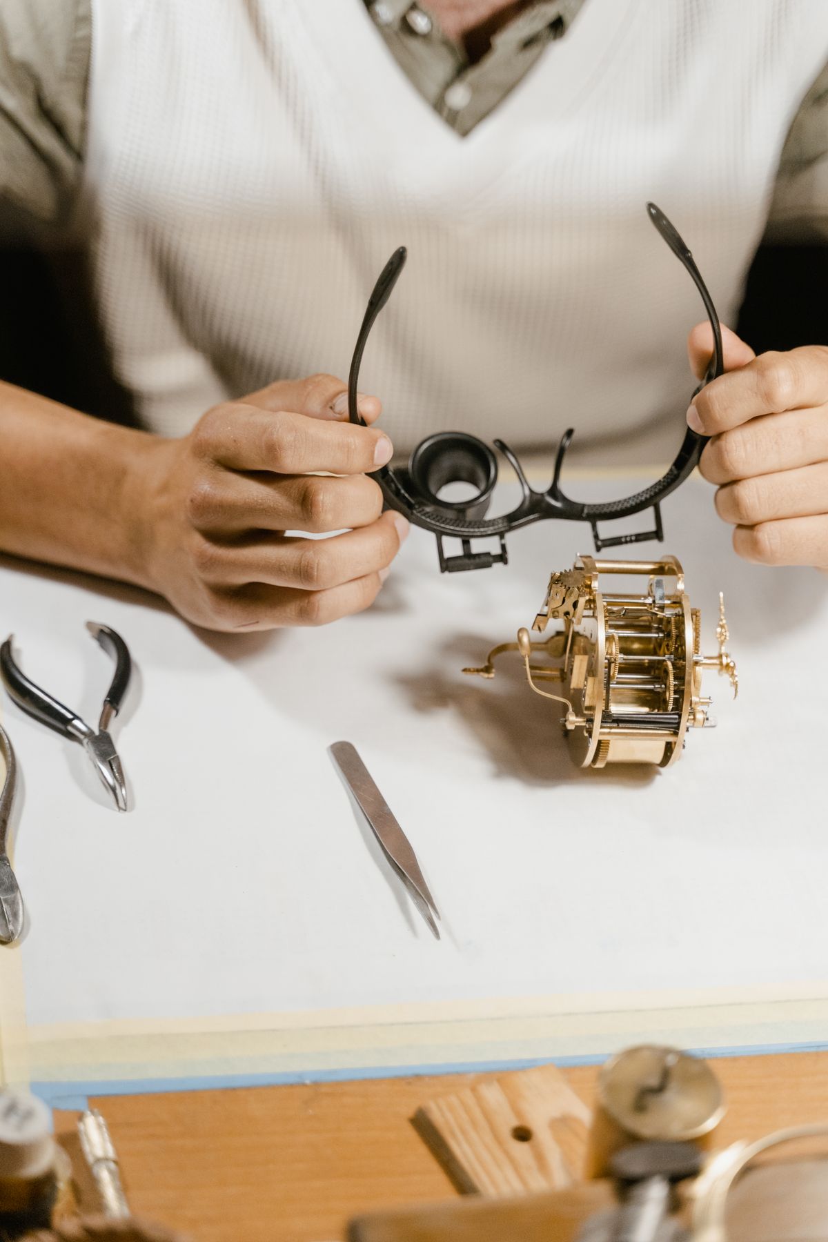 Watchmaker inspecting a watch mechanism under magnification at Saltzman's Watches