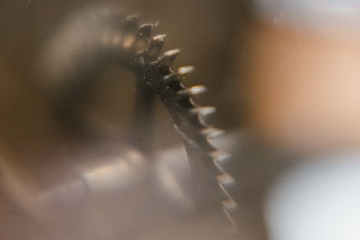 Intricate mechanical gear captured in a blurred close-up, highlighting details.
