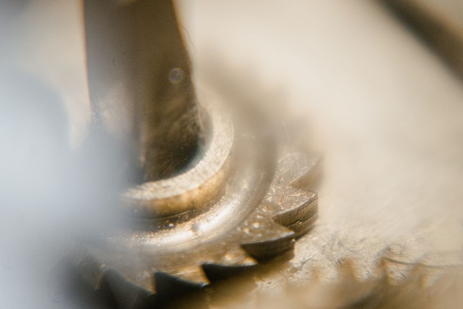 Detailed macro shot of interlocking gears showcasing mechanical intricacy.