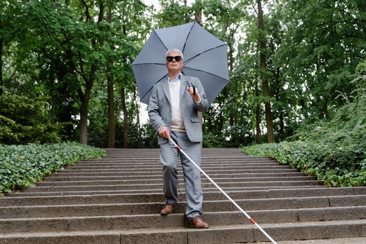 Blind Man Walking Down The Stairs