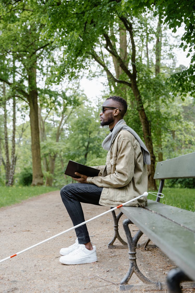 A Blind Man Sitting On A Bench