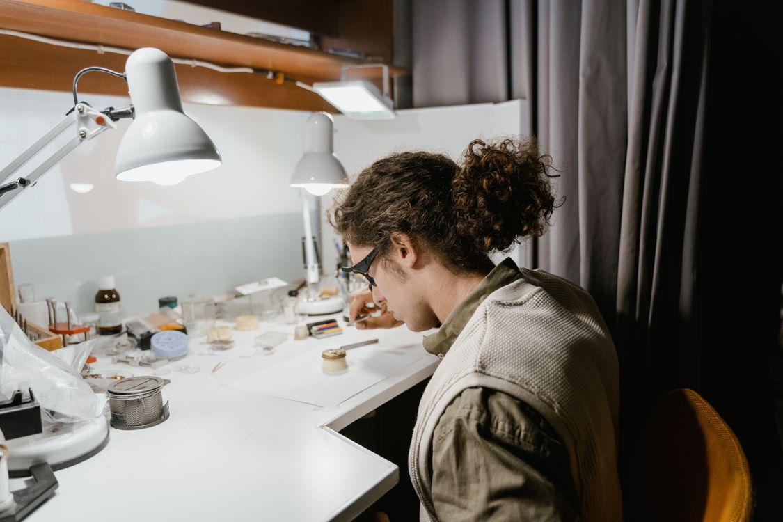 Watchmaker with Magnifying Glasses Fixing Watch · Free Stock Photo