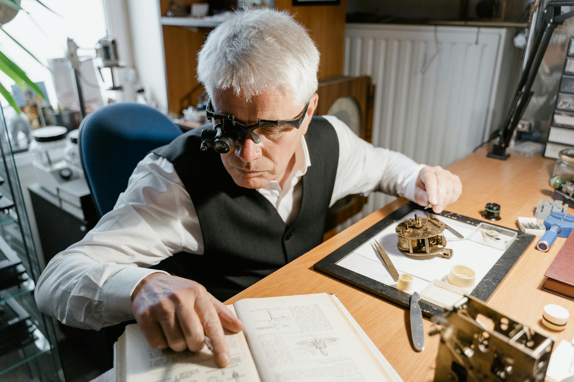 An elderly man intricately working on a timepiece with precision tools.