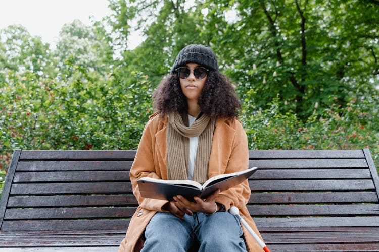 A Blind Woman Reading A Braille Book