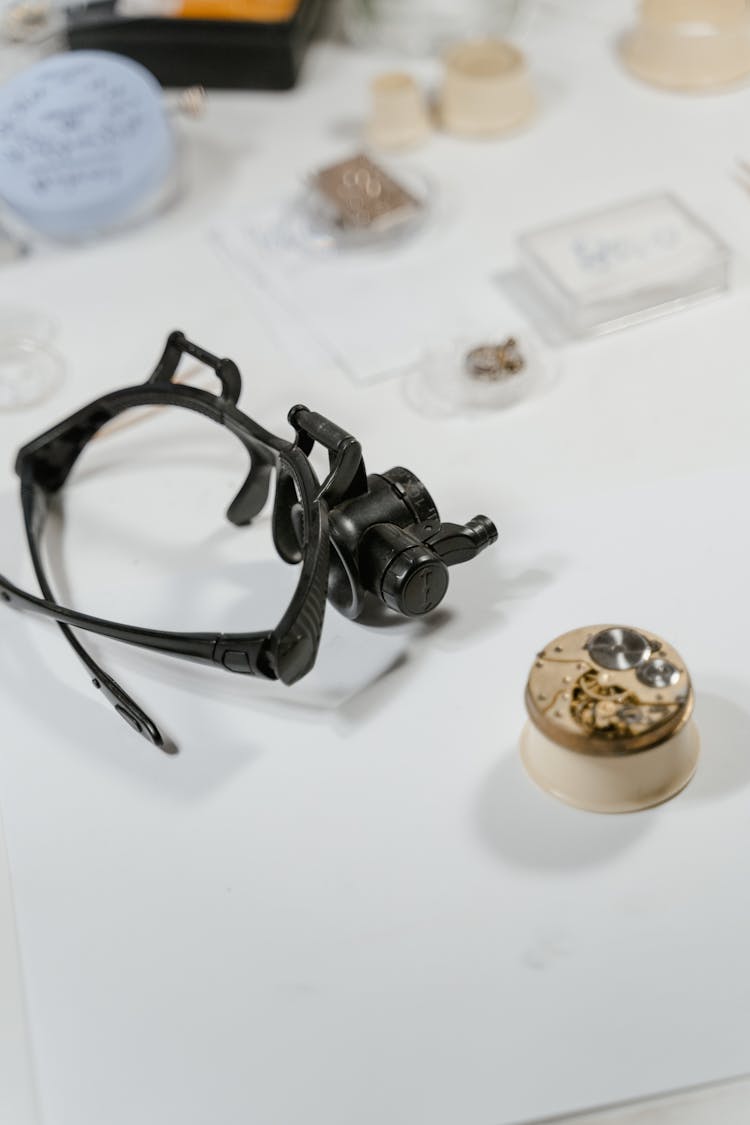 Magnifying Glasses By Watch Mechanism On Desk