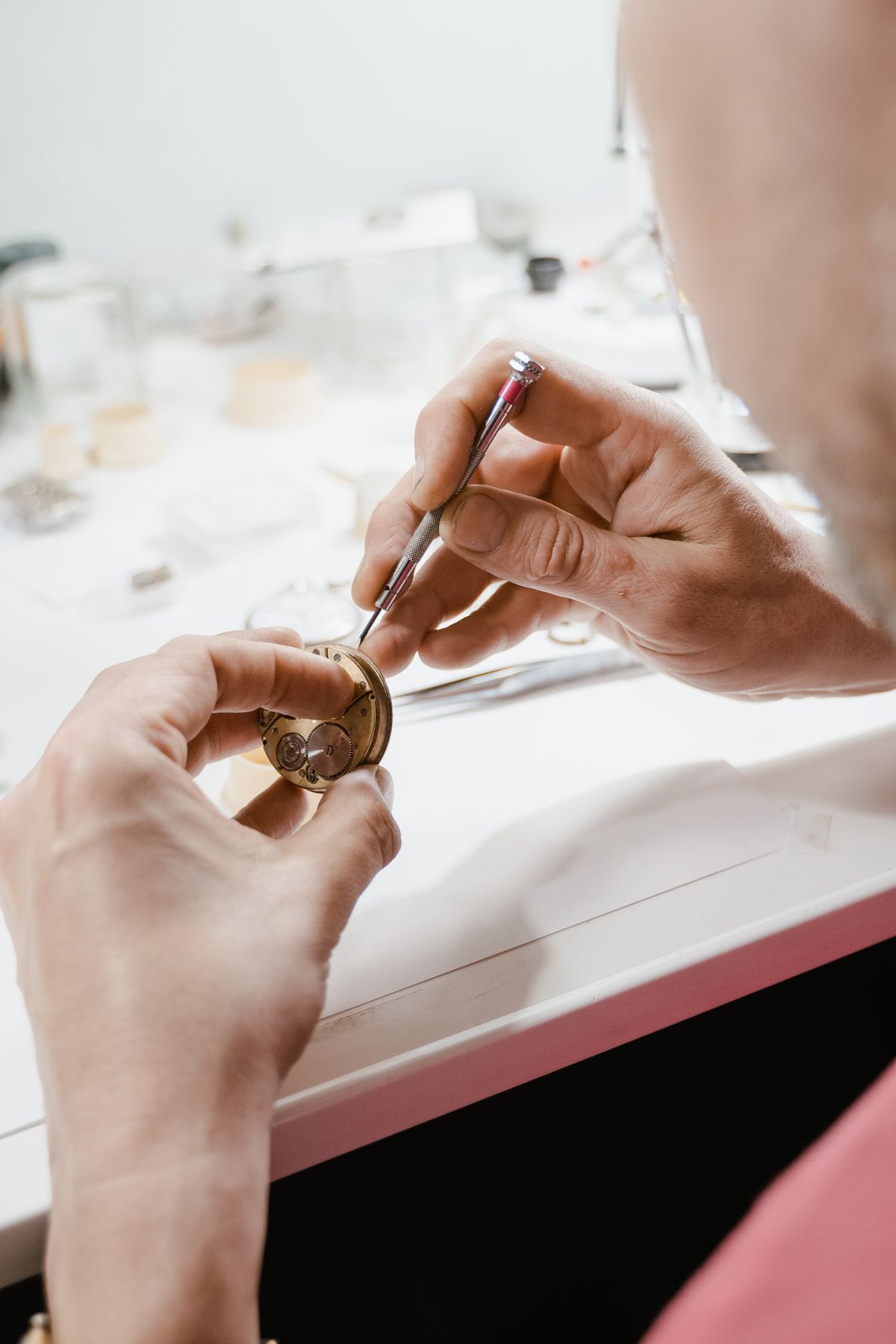 Watchmaker repairing a watch with precision tools at Saltzman's Watches