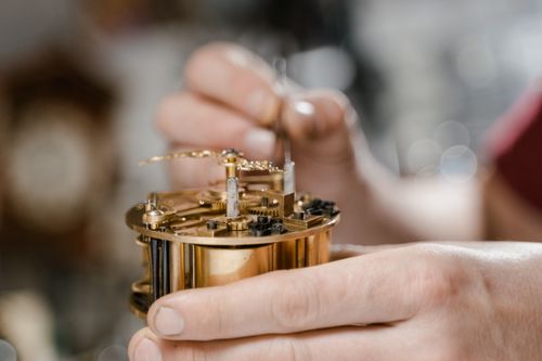 Free Close-up of a watchmaker repairing a mechanical watch, showcasing delicate craftsmanship and precision. Stock Photo