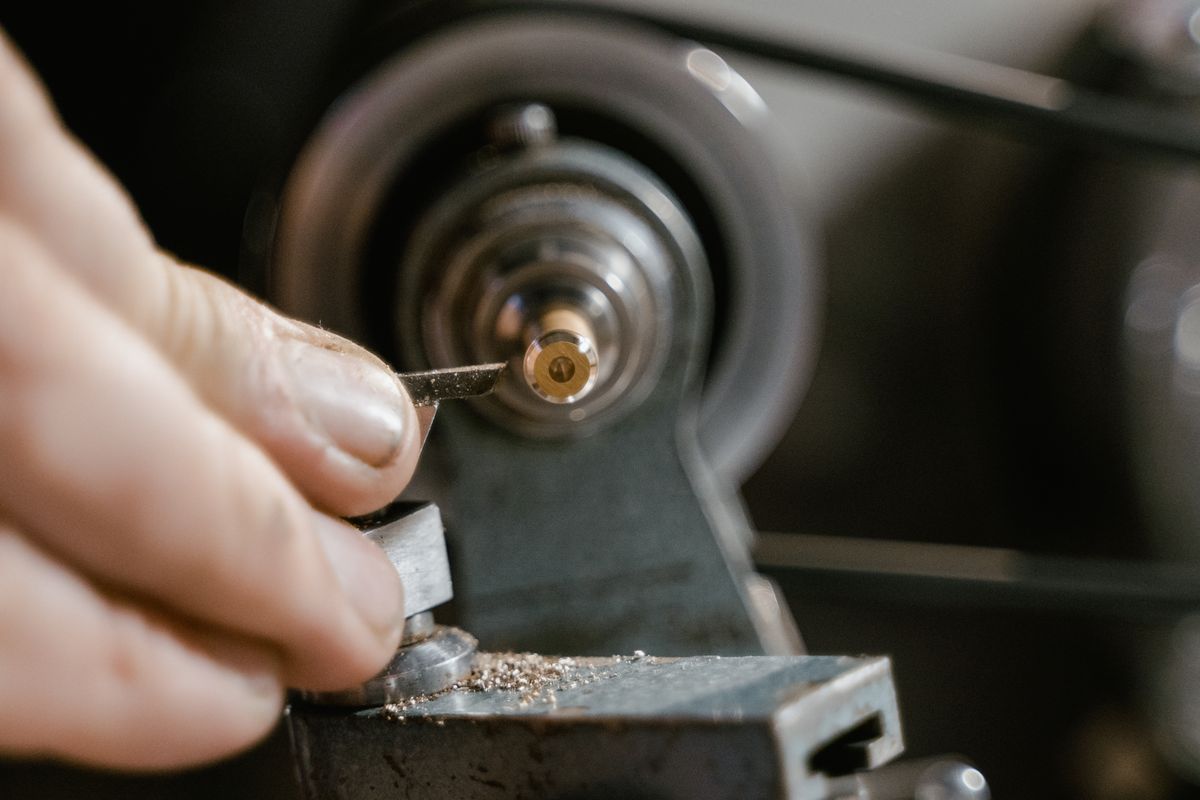 A metal component being formed on a lathe at the works
