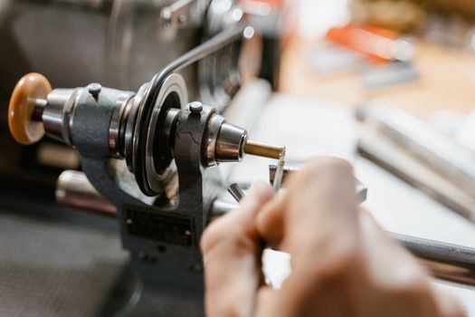 Watchmaker Using Lathe to Repair a Watch Component