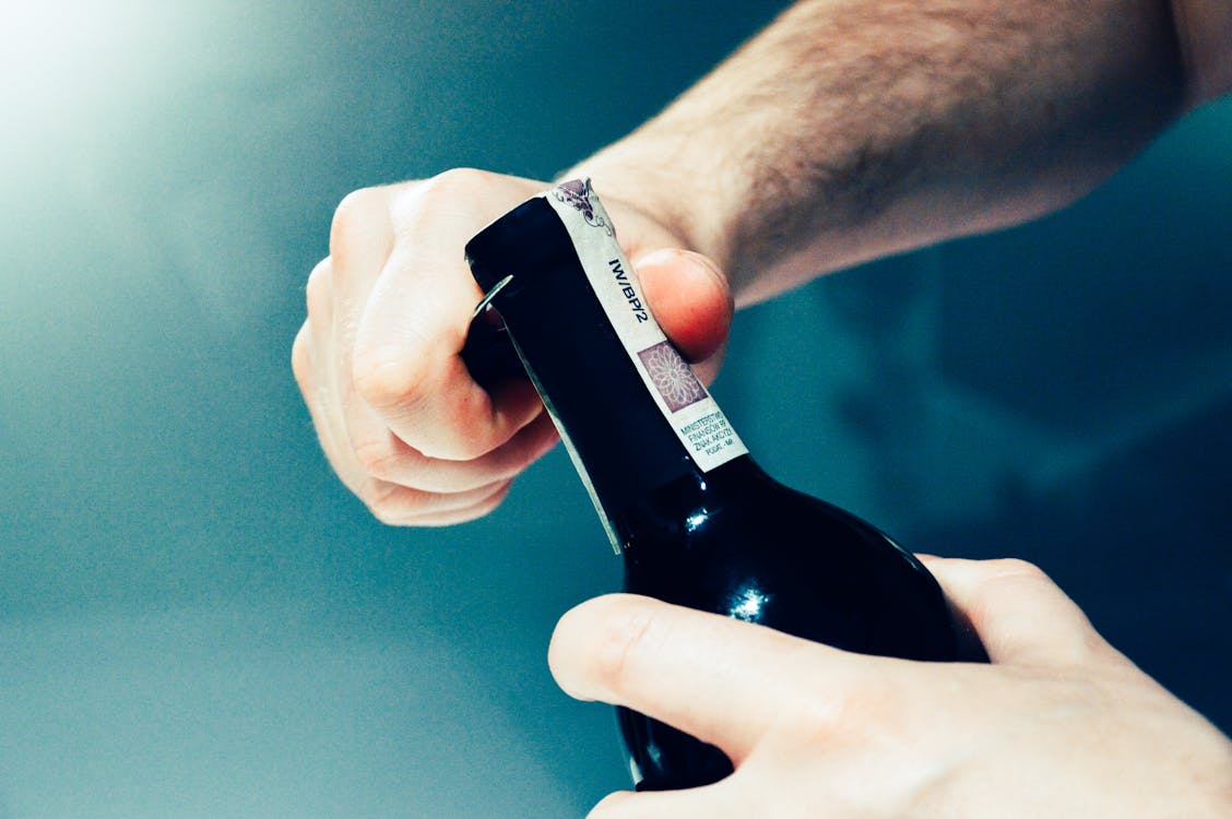 Free Person Opening the Bottle Stock Photo