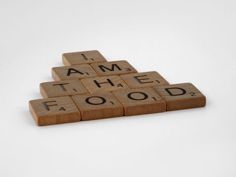 Scrabble tiles forming an intriguing message on a white background.