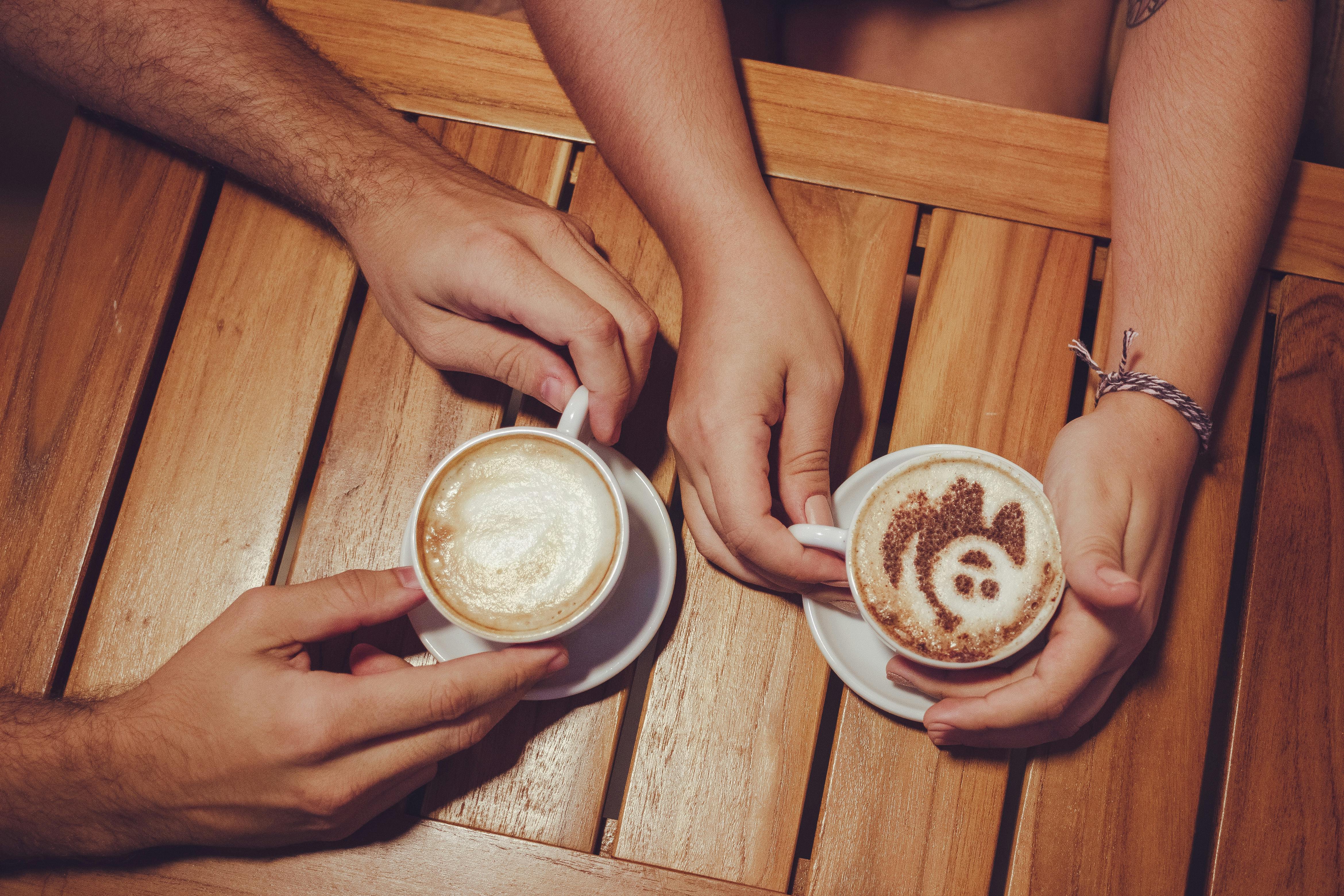 Two People Holding White Cup With Coffee Free Stock Photo