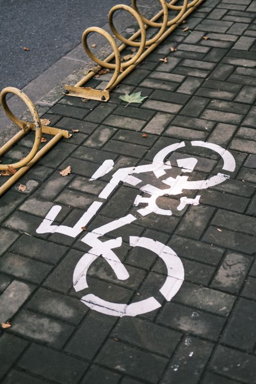 Free Close-up of bicycle lane marking on an urban pavement with bike rack. Stock Photo