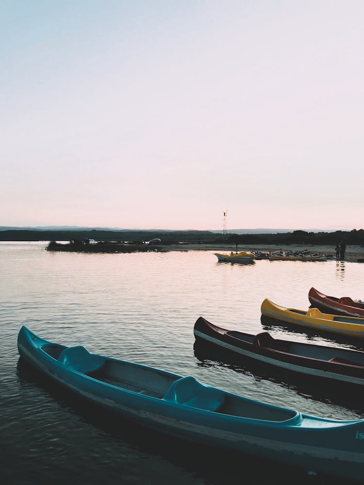 Photo Of The Lake With Kayaks At Sunset 