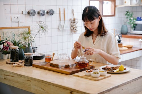 Photo of a Woman Making Tea in the Kitchen 