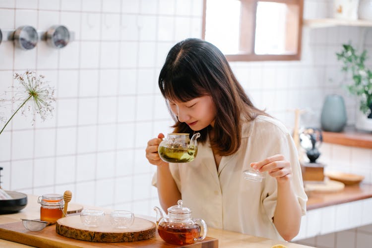 Woman Making Tea At Home Kitchen