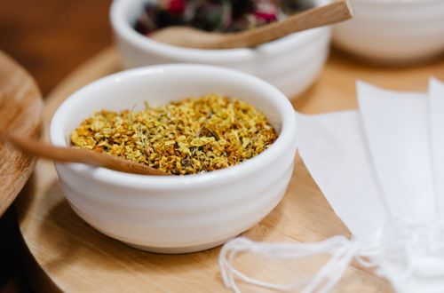 Free A detailed shot of dried spices in a ceramic bowl with a wooden spoon, ideal for kitchen themes. Stock Photo