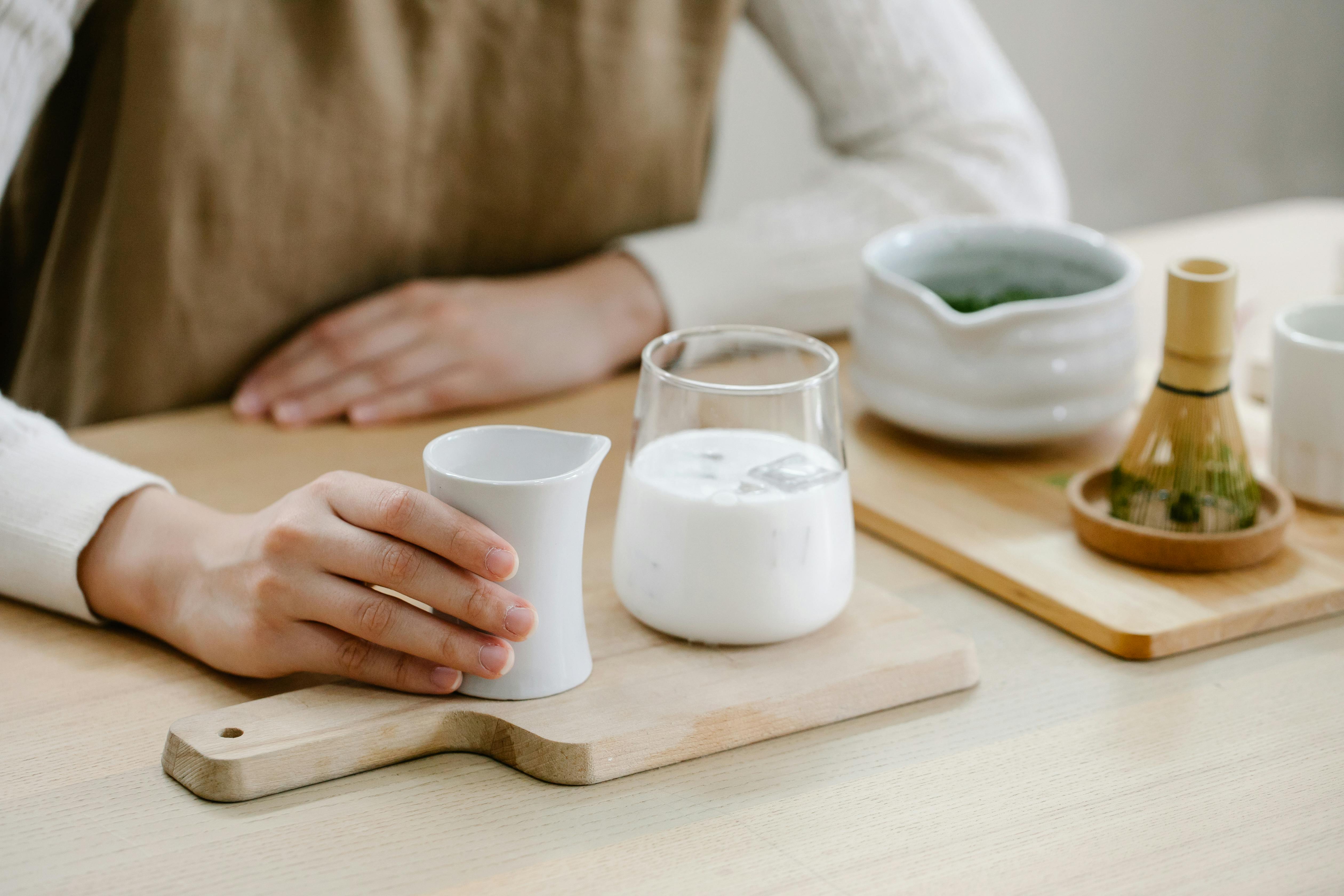 person sitting with a glass of milk