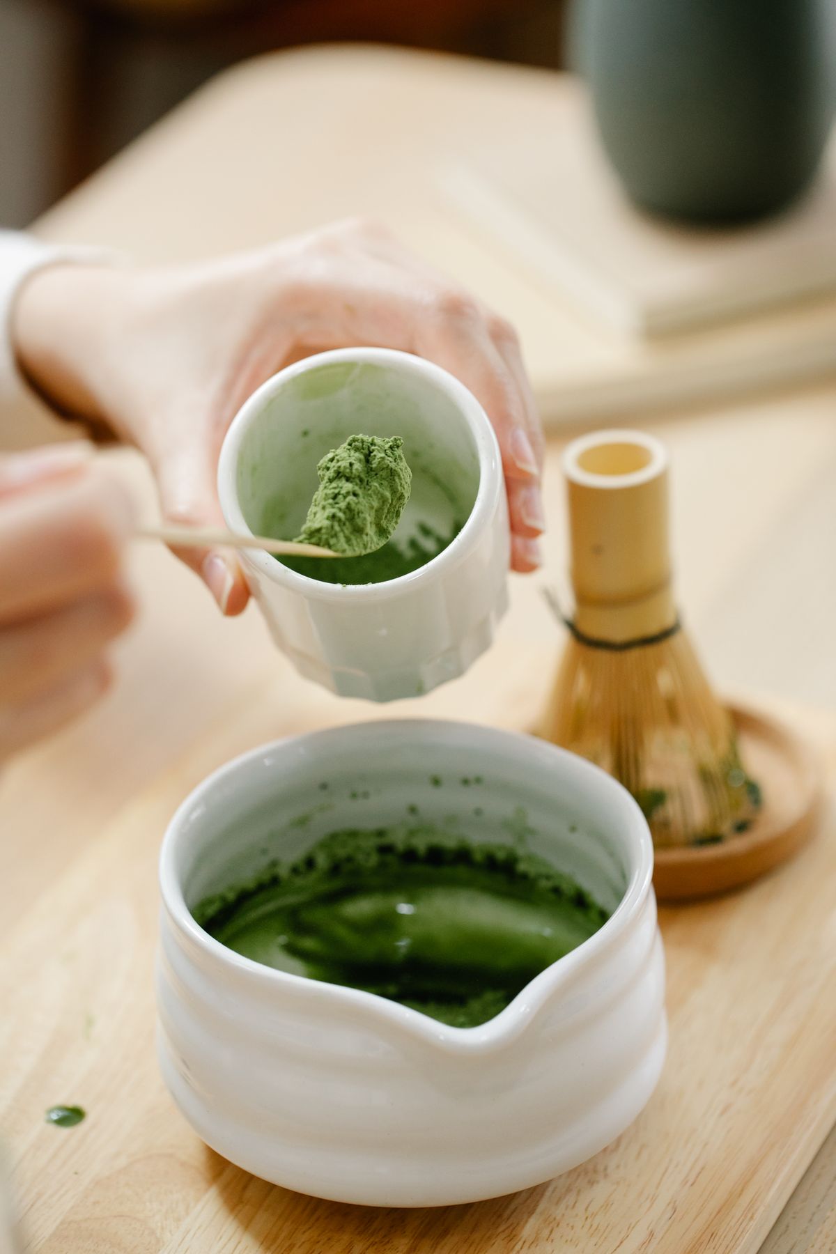 Matcha-Paste wird aus Becher in Chawan gegeben, Schritt-für-Schritt Zubereitung mit Chasen