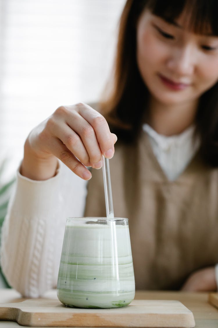 Woman Stirring Matcha Drink 