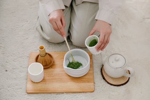 Person Making Traditional Matcha Tea