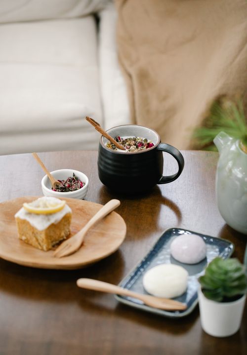 Free Warm indoor scene of cake and tea on a rustic wooden table with decorative elements. Stock Photo