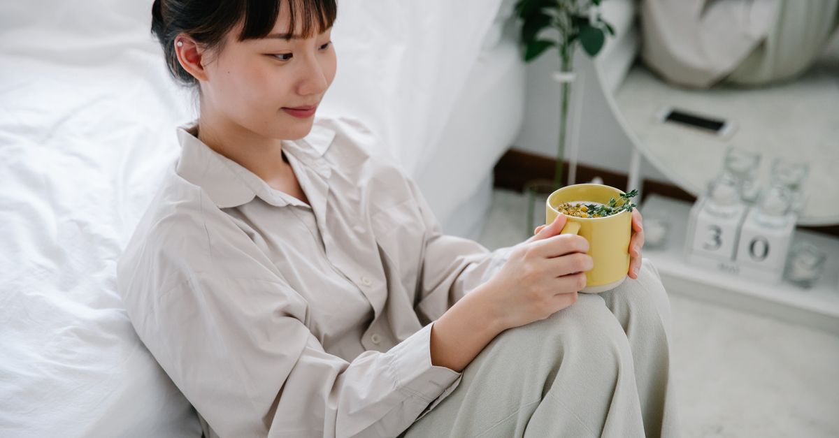 woman relaxing with tea after sunday reset routine evening