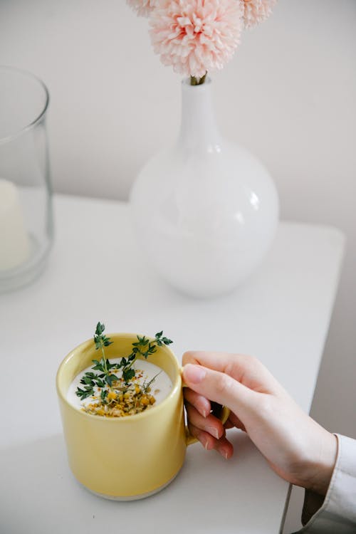 Close-up of Person Hand with Tea in Mug