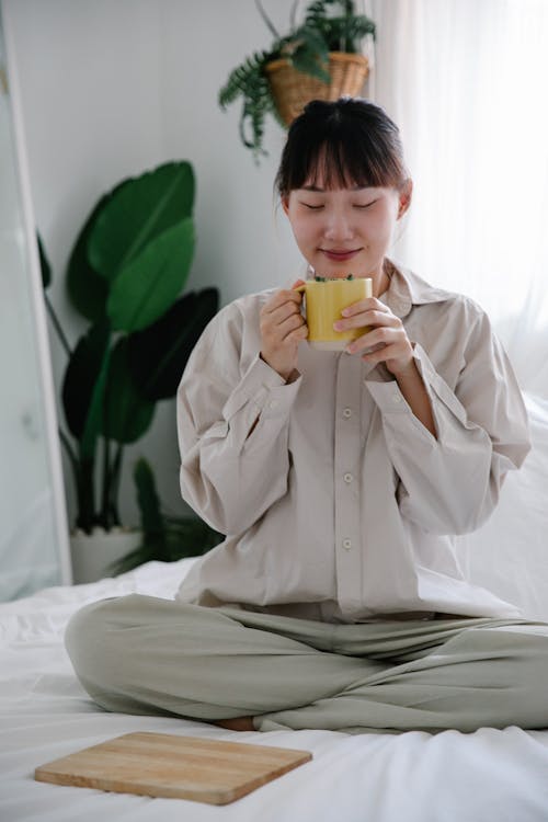 Free Woman Enjoying Tea in Bed  Stock Photo