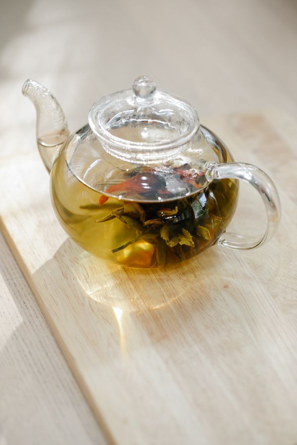 A glass teapot holding freshly steeped leaf — photo by Anna Pou on Pexels