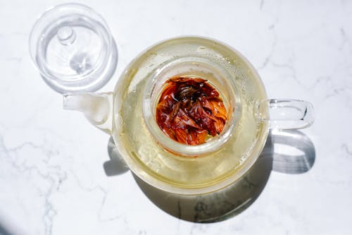 Free Tea in Glass Teapot on Table Stock Photo