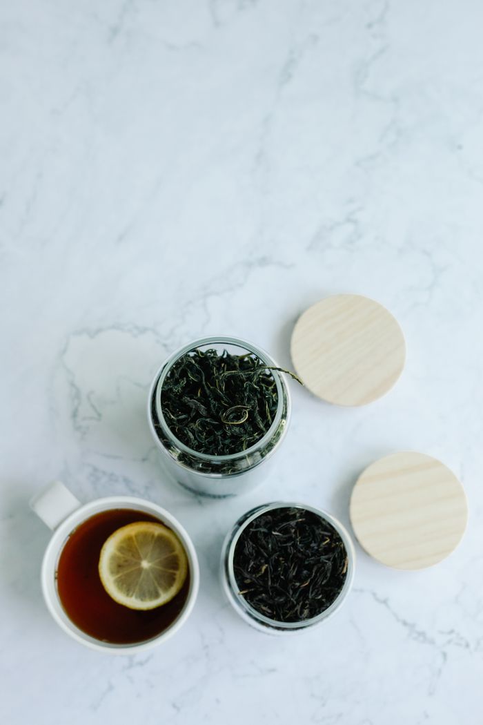 Tea ingredients and cup arranged for tasting