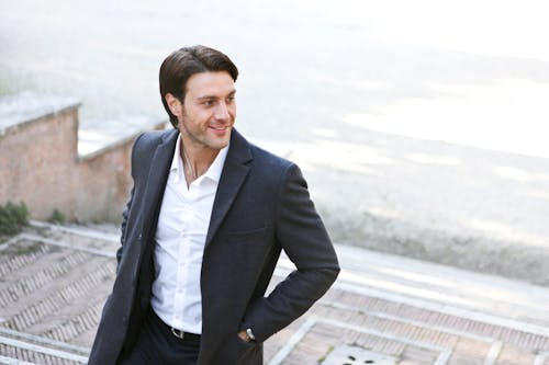 Free Man in White Dress Shirt and Black Blazer Standing Outside Building Stock Photo