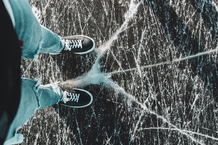 Person Standing On Cracked Ice Surface