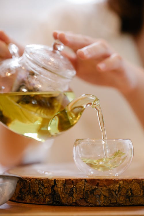 Free Person Pouring Tea in a Cup Stock Photo