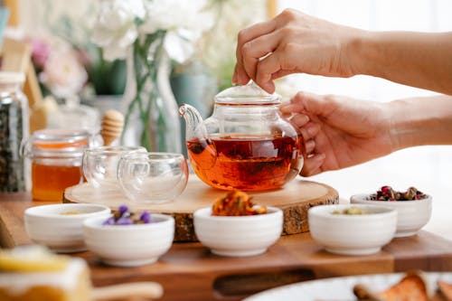 Free Person Holding Clear Glass Teapot Stock Photo