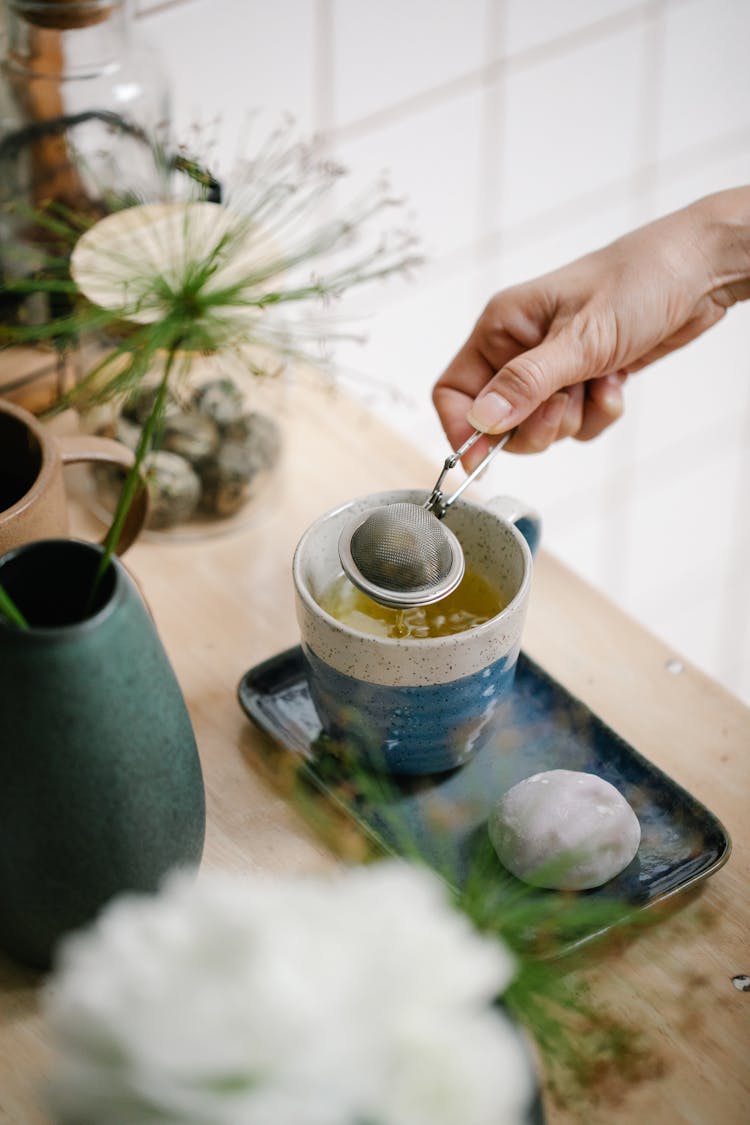 Close-up Of Person Making Tea