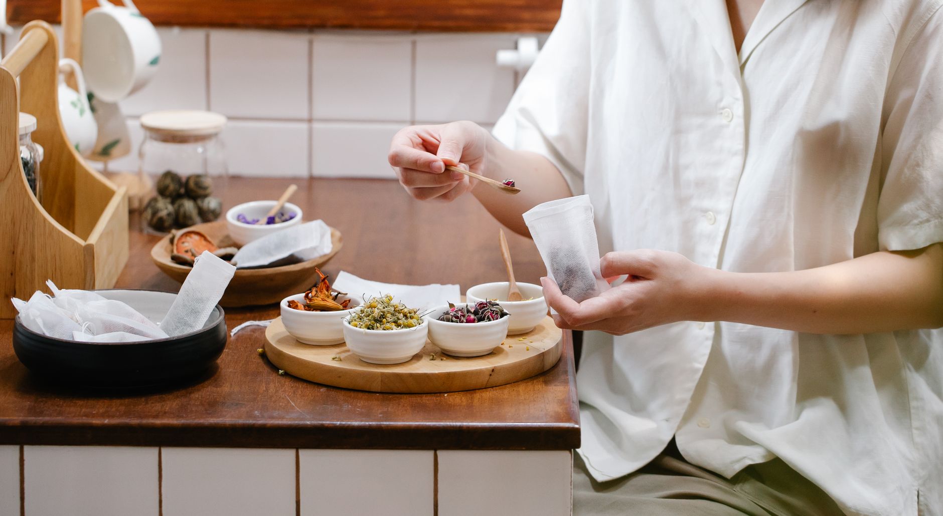 Loose leaf tea and dried botanicals arranged on a tea blending table