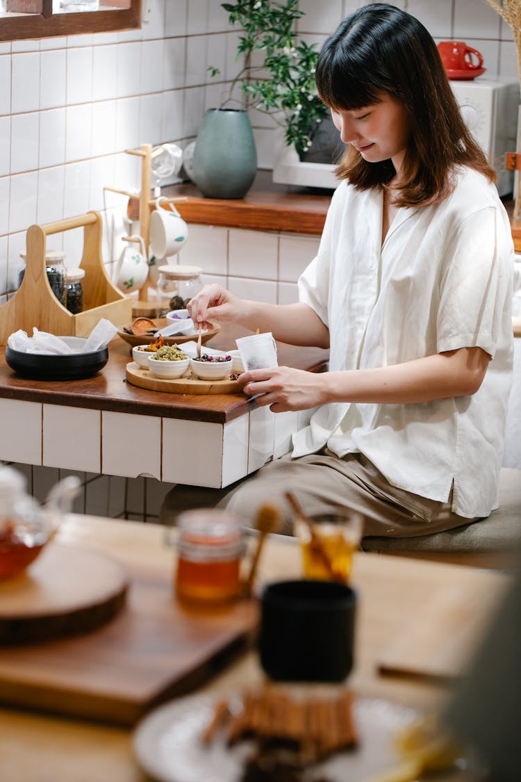 Young Woman Preparing Infusion Mixtures 