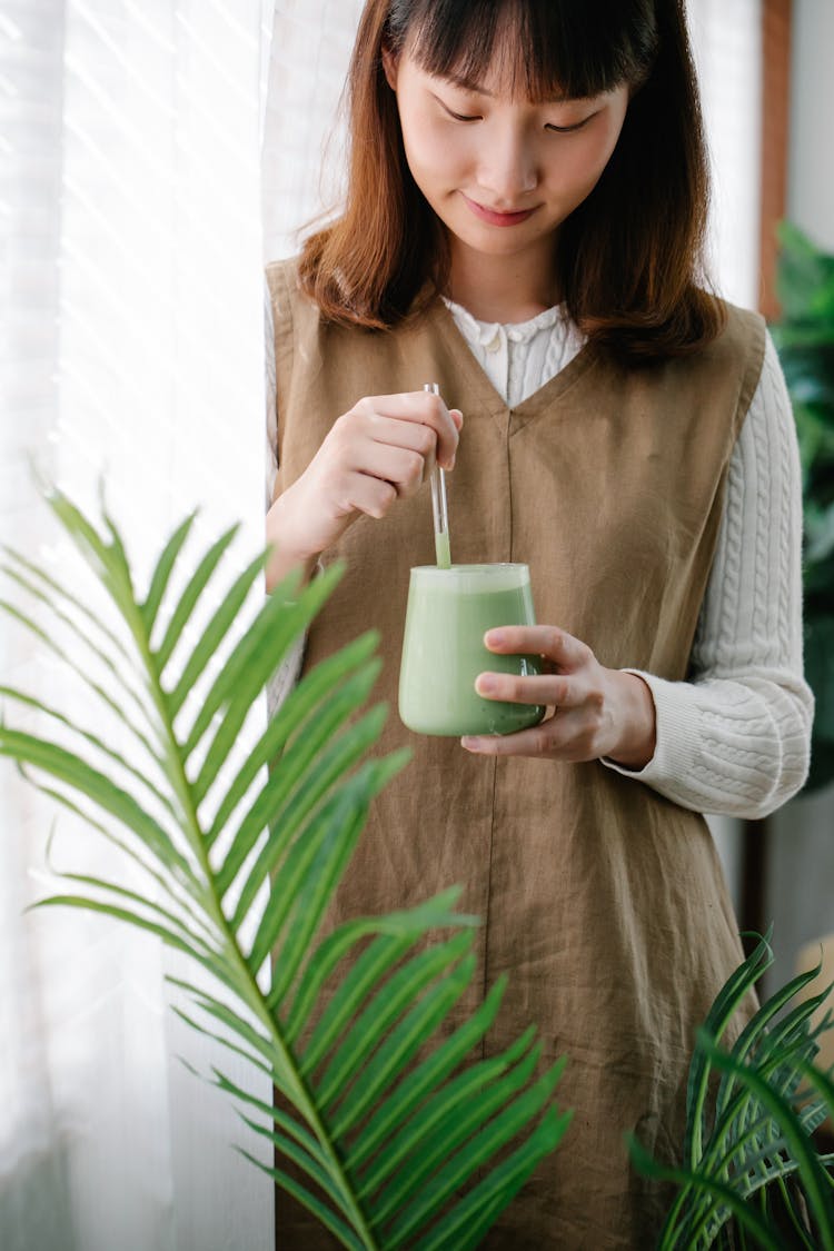 Woman Drinking Matcha From Glass