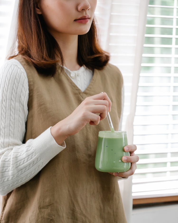 Woman With Green Milkshake In Glass