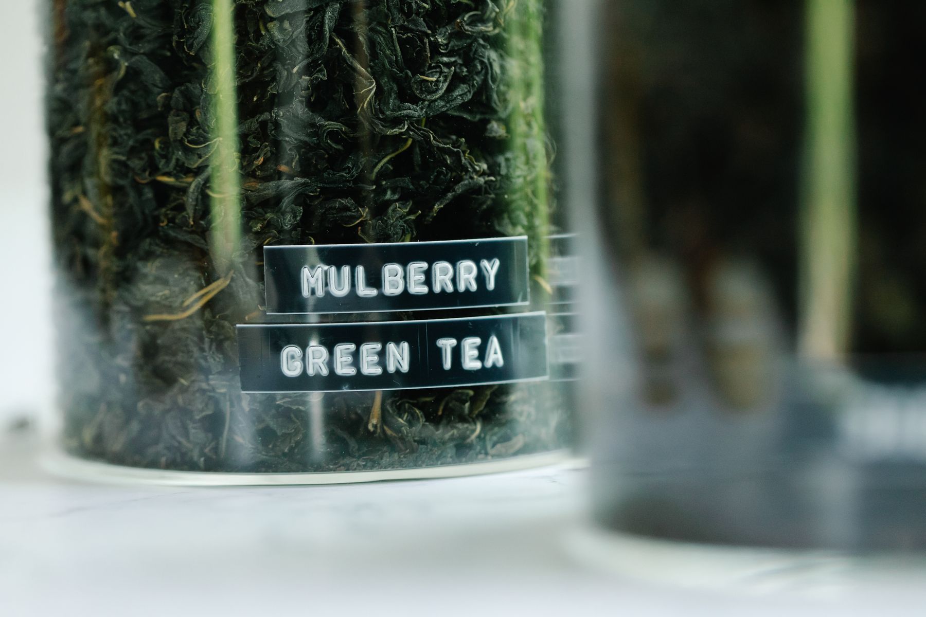 Dried tea leaves stored in clear glass jars