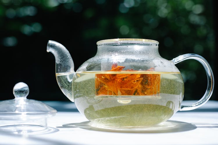 Glass Teapot With Tea Brewing Inside It 