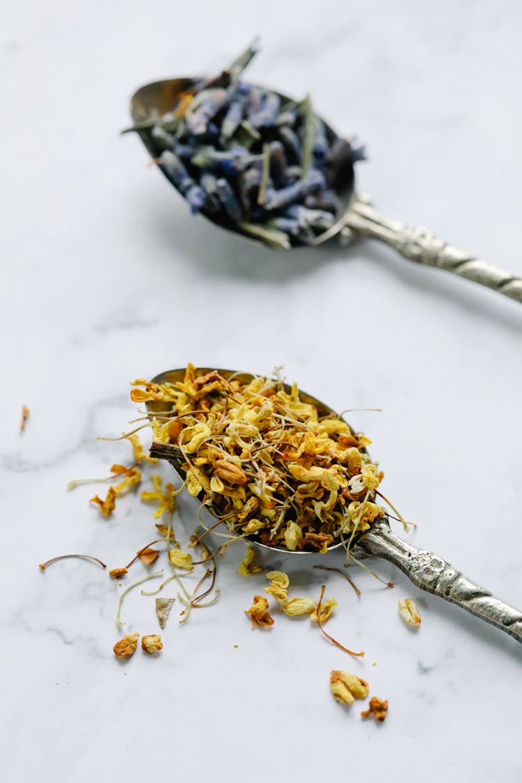 Dried Flowers On Teaspoons In Close Up Photography