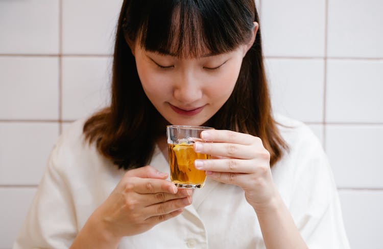 Woman Drinking Tea From Glass